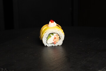 Traditional japanese nigiri sushi, separated on black stone background