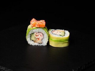 Traditional japanese nigiri sushi, separated on black stone background