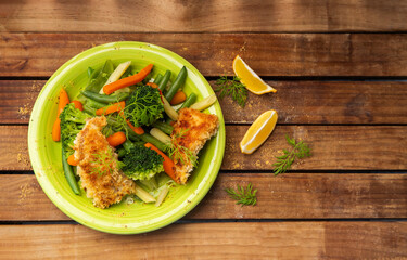 fried fish fillets served with vegetables, main dish, low fat diet, healthy lifestyle and eating