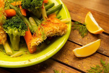 fried fish fillets served with vegetables, main dish, low fat diet, healthy lifestyle and eating
