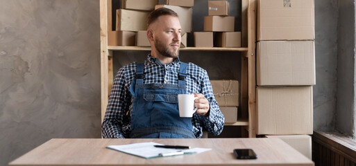 Small and medium business business concept young caucasian bearded man working and smiling at home...
