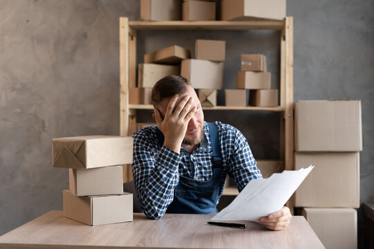 Frustrated Frustrated Young Business Owner Reading Bad News In Mail Letter, Paper Document, Depressed Tense Guy Worried About High Tax Bill, Bad Debt Notice, Money Problem