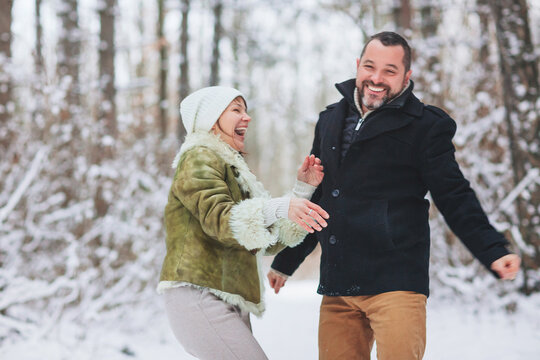 Lovely Happy Middle-aged Family Couple Having Fun Outdoors In Winter Season Together