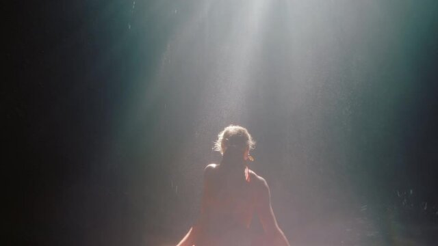 beautiful woman dancing in waterfall cave wearing beautiful dress enjoying dance feeling spiritual freedom 4k