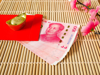 Stack of Chinese yuan money in red envelope