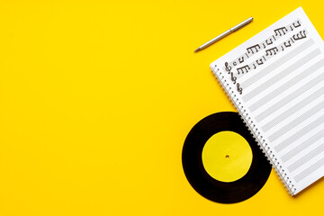 Sheets with music notes and vinyl record. Compose music concept