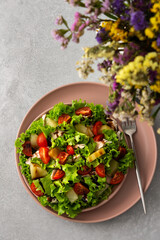 Light summer fresh salad with tomatoes and lettuce, chicken breast and pineapple with balsamic sauce, top view
