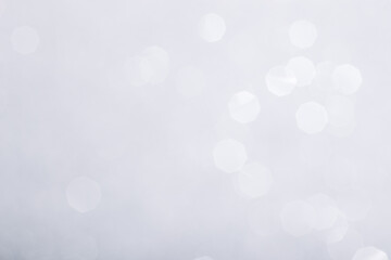 Silver glowing sparkles blurred background