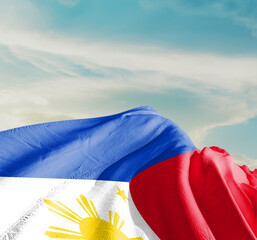 Philippines national flag cloth fabric waving on the sky with beautiful sun light - Image