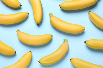 Sweet ripe baby bananas on turquoise background, flat lay
