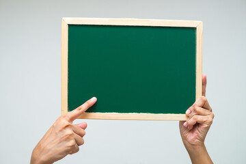 Isolated small blackboard with fingers,hands pointing towards board