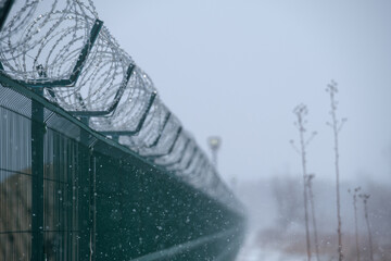 barbed wire fence in cold and hard condition. Barbed wire of restricted area