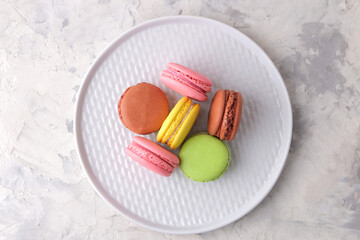 Macaroons on a light background. Sweet French cake, different types of macarons.