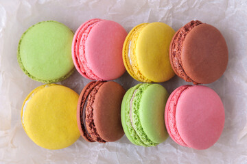 Macaroons on a light background. Sweet French cake, different types of macarons.