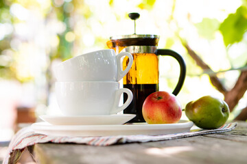 Breakfast serving for two, tea cups and fruits