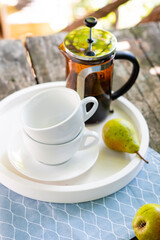 Breakfast serving for two, tea cups and fruits