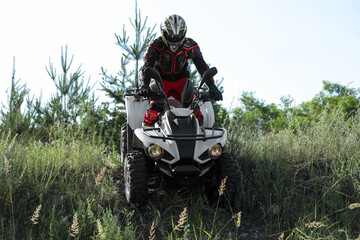 Man driving modern quad bike outdoors. Extreme sport