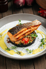 Gourmet salmon fillet with creamy basil sauce and black rice