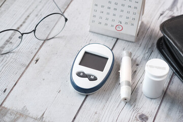 Close up of diabetic measurement tools and pills on color background 