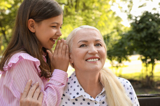 Mature woman with her little granddaughter in park