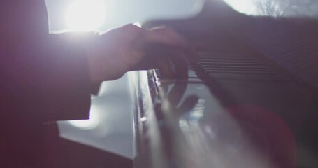 4K Footage of male hands playing grand piano . Man touches fingers on keys . Pianist plays in beautiful grand piano on stage in concert . Close up . Shot on ARRI ALEXA movie camera in slow motion .