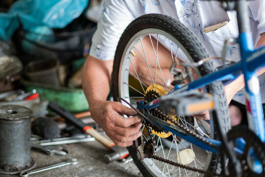 Mechanic repairing wheel of bicycle, maintenance and clean
