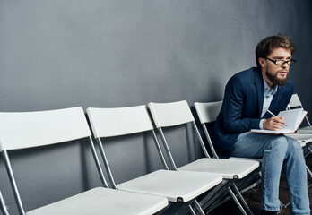 male manager sitting on a chair resume job Copy Space