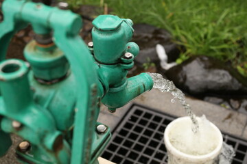Japanese old pump drains water from well