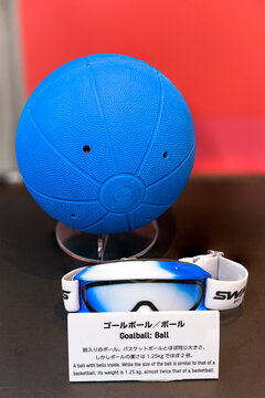 tokyo, japan - august 30 2021: Rubber jingling ball with soundholes and goggles used by disabled and blind athletes in goalball exhibited at Paralympic Gallery Ginza.