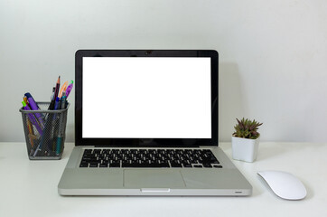 Fototapeta premium computer laptop mock up and mouse Cactus white blank screen on table. Used to advertise text on the computer screen.