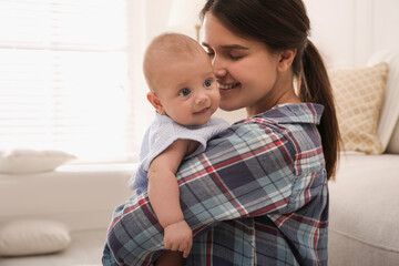 Happy young mother with her cute baby at home