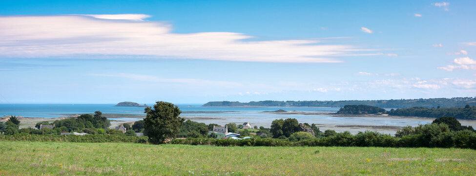 countryside in french brittany under blue sky in summer near paimpol