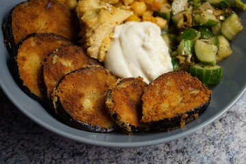 Vegan hummus bowl with crispy eggplant chickpeas peppers vegetables fresh salad