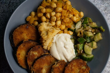 Vegan hummus bowl with crispy eggplant chickpeas peppers vegetables fresh salad