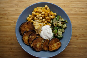 Vegan hummus bowl with crispy eggplant chickpeas peppers vegetables fresh salad