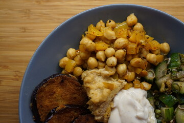Vegan hummus bowl with crispy eggplant chickpeas peppers vegetables fresh salad