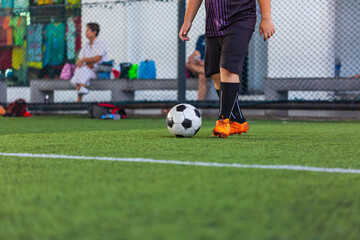 Children playing control soccer ball tactics on grass field with for training