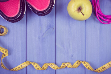 Sport shoes, accessories for fitness and fresh apple. Healthy sporty lifestyles. Place for text