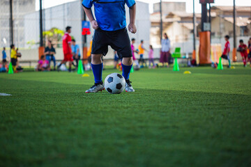 Children playing control soccer ball tactics on grass field with for training