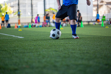 Obraz premium Children playing control soccer ball tactics on grass field with for training