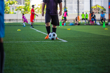 Obraz premium Children playing control soccer ball tactics on grass field with for training