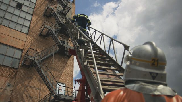 Unrecognizable firefighter climbing down ladder