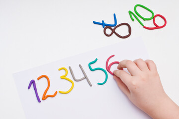 Colorful digits made from plasticine. Bright colored volumetric figures for children (isolated on white)