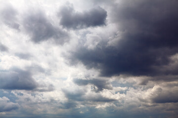 Sky covered by grey cumulus clouds . Rainy overcast 