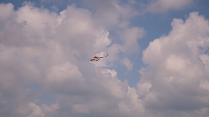 Helicopter flying in cloudy sky