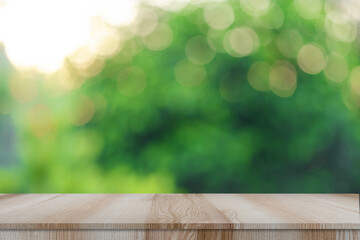 Empty modern brown wooden table with bokeh green nature background