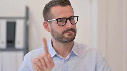 Portrait of Middle Aged Man showing No Sign by Finger 