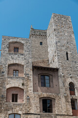 Fototapeta na wymiar The historic center of San Gimignano, a typical medieval village in Tuscany. Narrow streets, numerous stone towers characterize the urban landscape