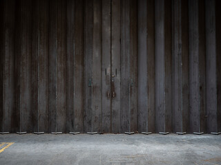Metal shuttered doors. Abstract view of some large and well-used retro industrial metal concertina doors on the side of a London bus depot.