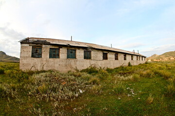 Fototapeta na wymiar Abandoned building in a natural landscape in Khakassia